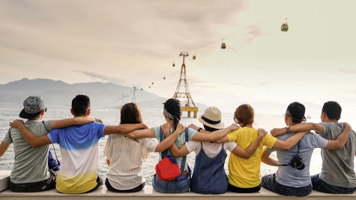Friends meeting outdoors and laughing together